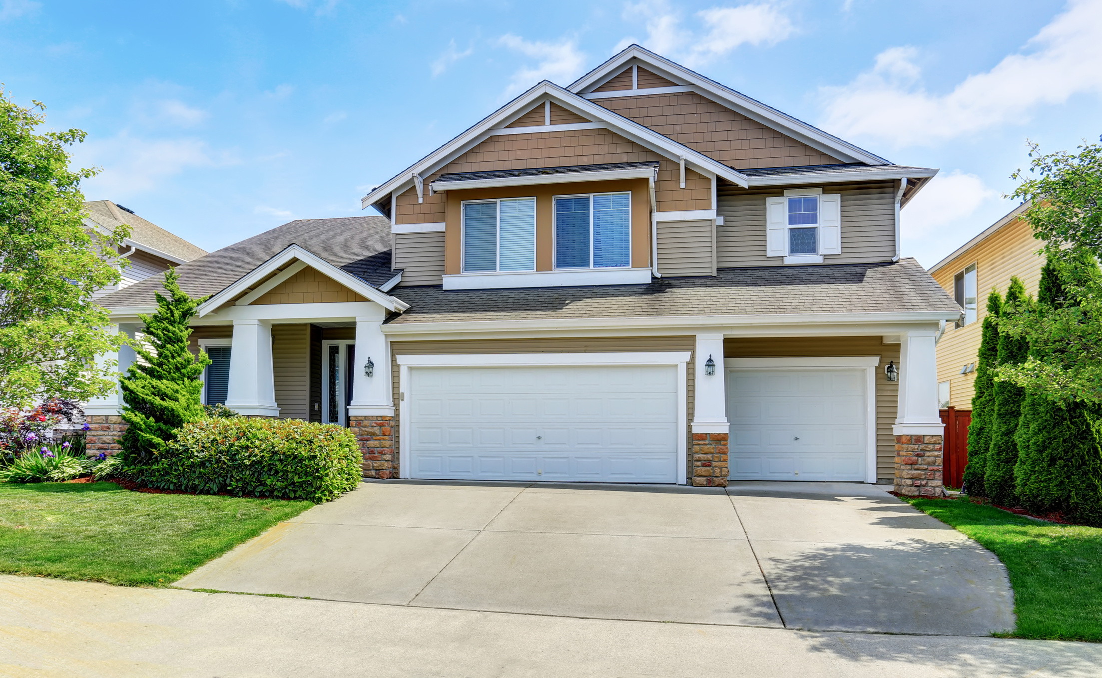 Classic American house exterior with siding trim and garage.